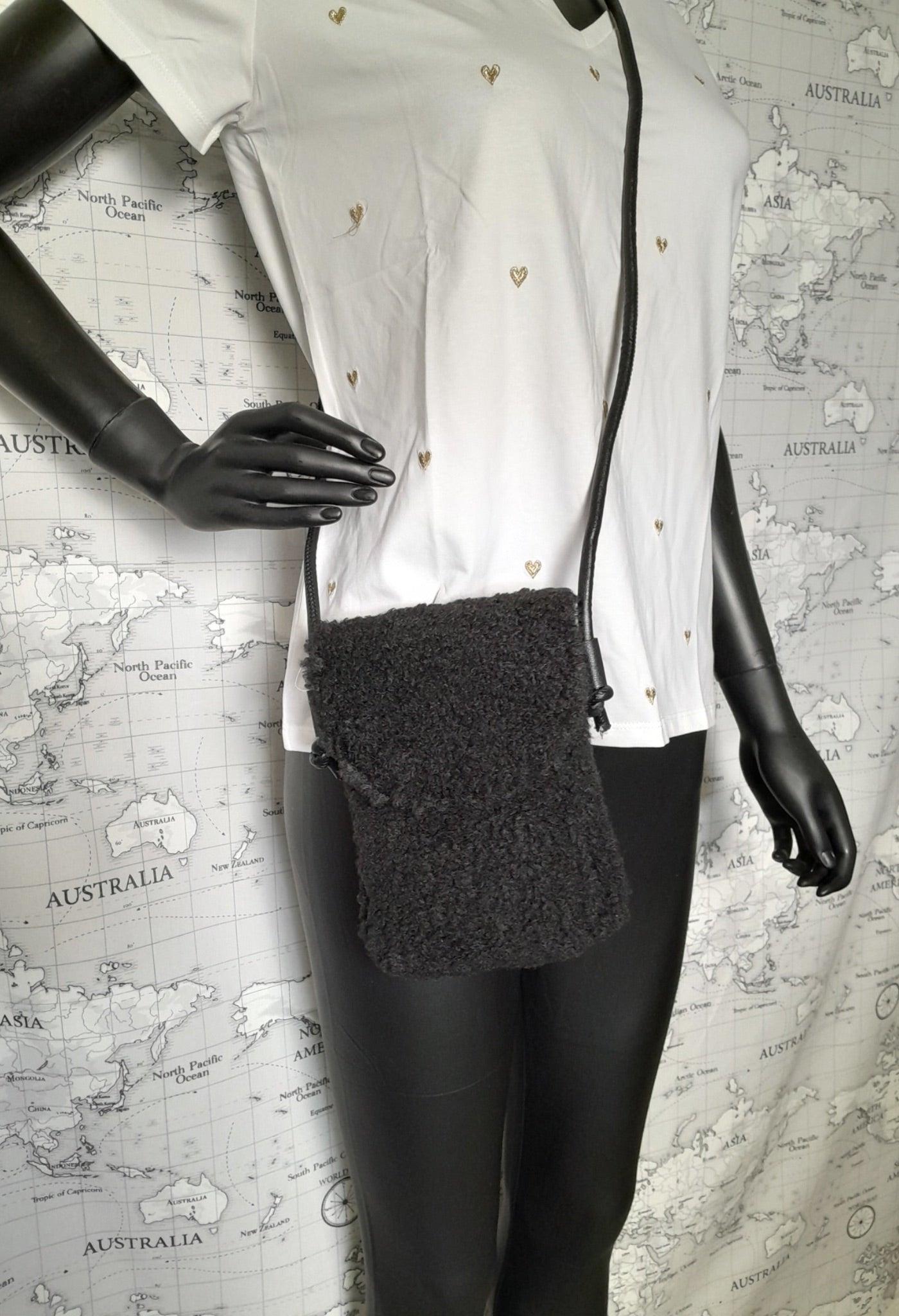 Black faux fur crossbody pouch bag on mannequin, trendy accessory from Le Petit Placard