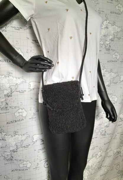 Black faux fur crossbody pouch bag on mannequin, trendy accessory from Le Petit Placard