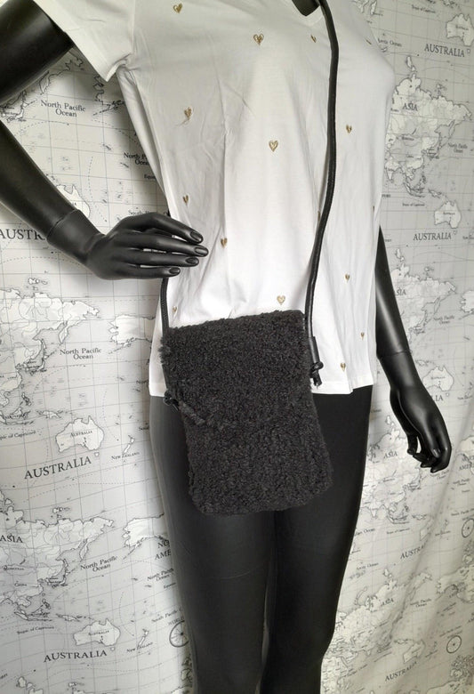 Black faux fur crossbody pouch bag on mannequin, trendy accessory from Le Petit Placard