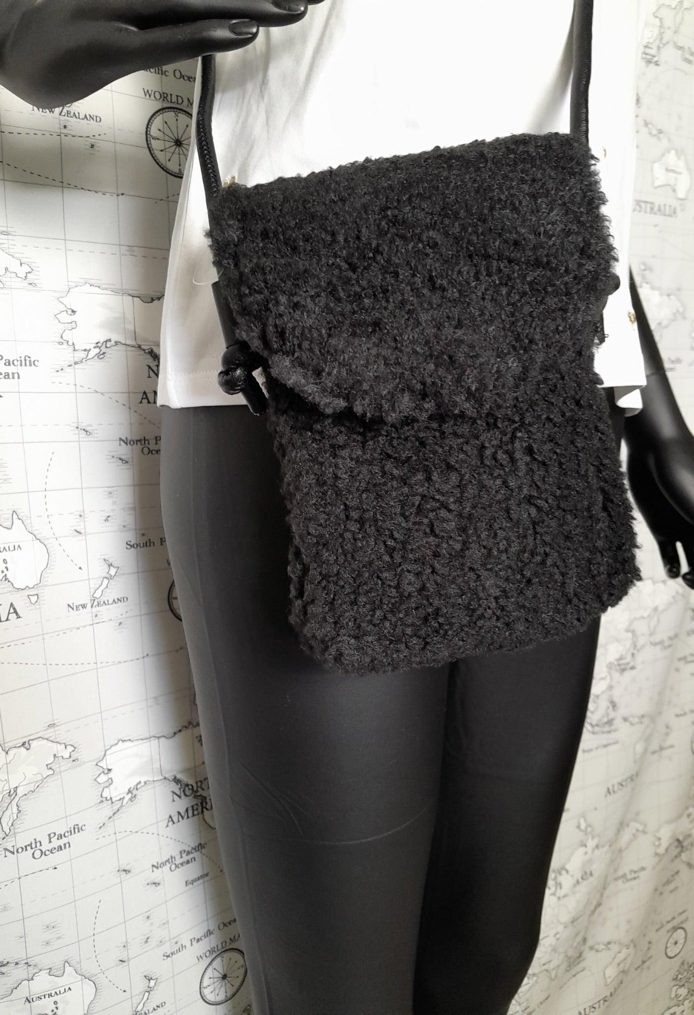 Black faux fur crossbody bag with flap, trendy accessory from Le Petit Placard