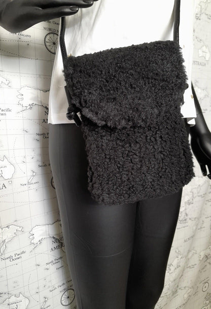 Black faux fur crossbody bag with flap, trendy accessory from Le Petit Placard