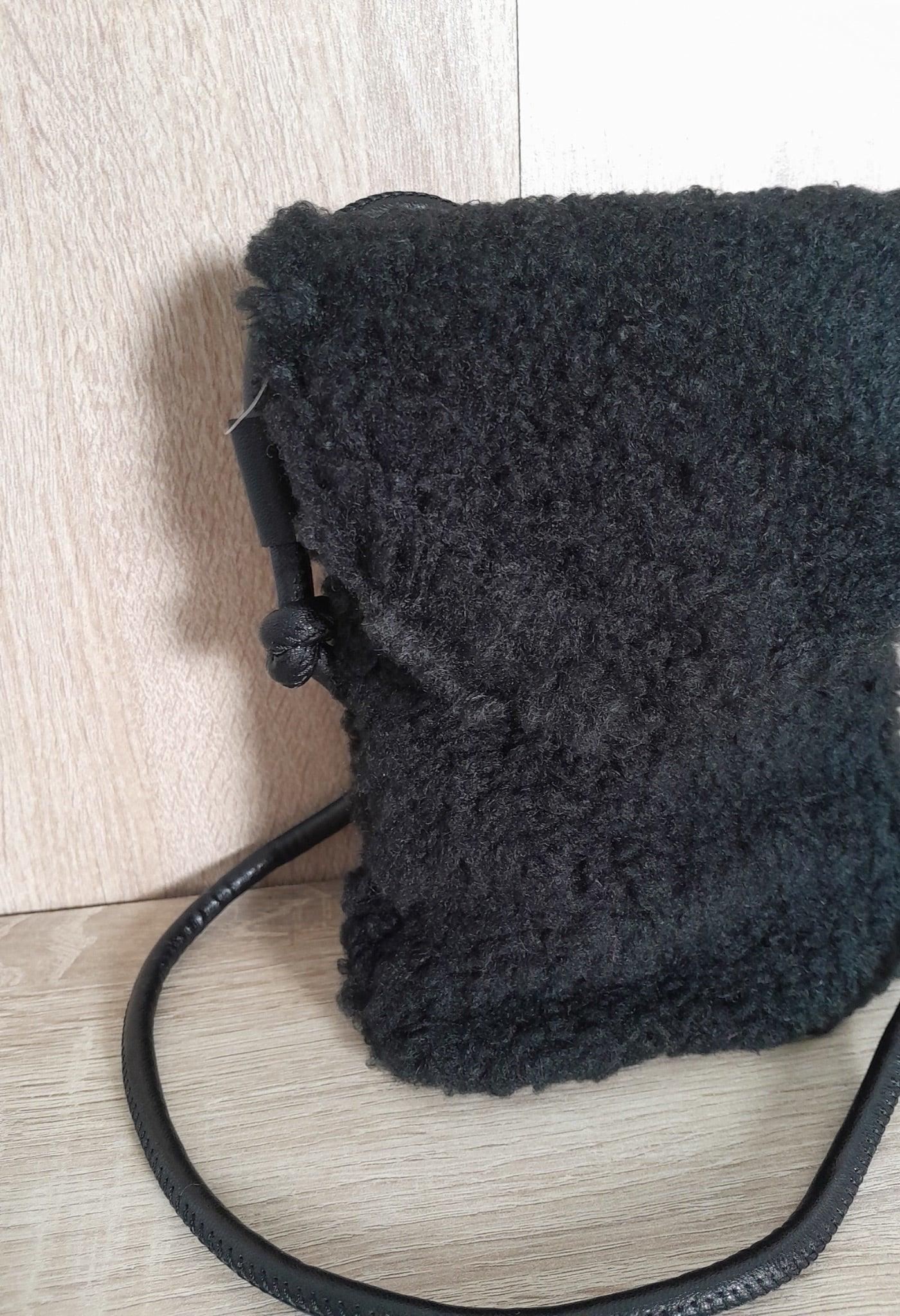 Black faux fur crossbody pouch bag with strap on wooden surface, Le Petit Placard accessory