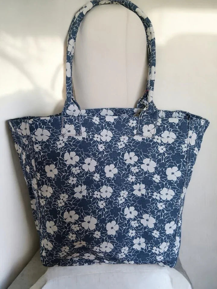 Navy blue floral tote bag with white flower pattern, stylish accessory from Le Petit Placard