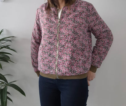 Woman wearing pink floral zip-up bomber jacket from Le Petit Placard, casual outfit style