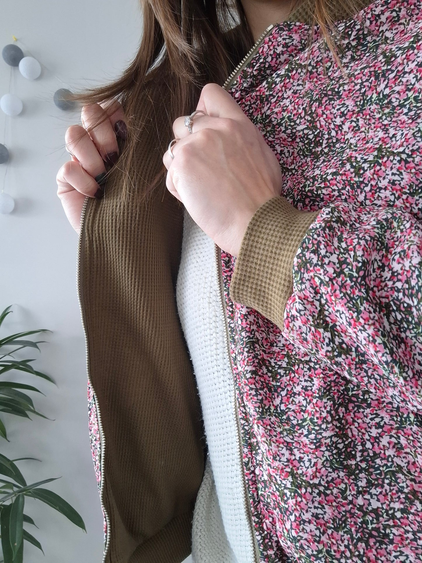 Woman wearing floral Laura Jo raincoat from Le Petit Placard, close-up on jacket detail