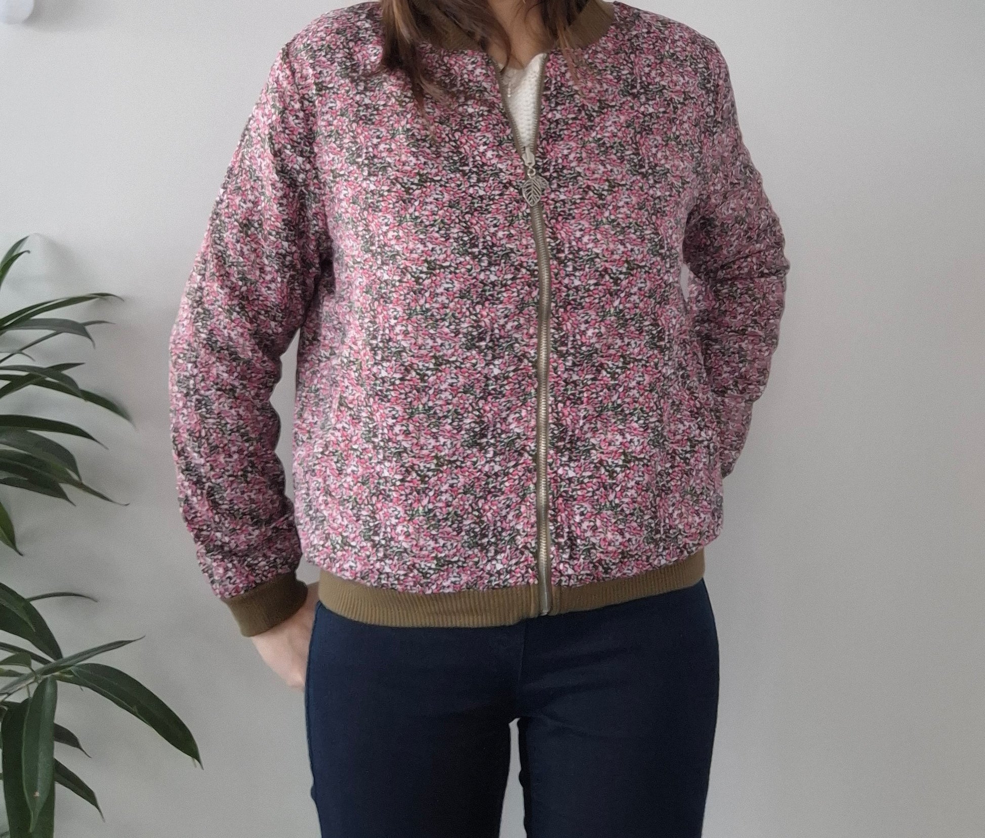 Woman wearing a pink floral Laura Jo jacket from Le Petit Placard, casual style indoors