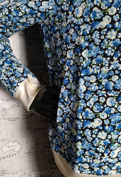 Blue floral bomber jacket with white ribbed cuffs from Le Petit Placard