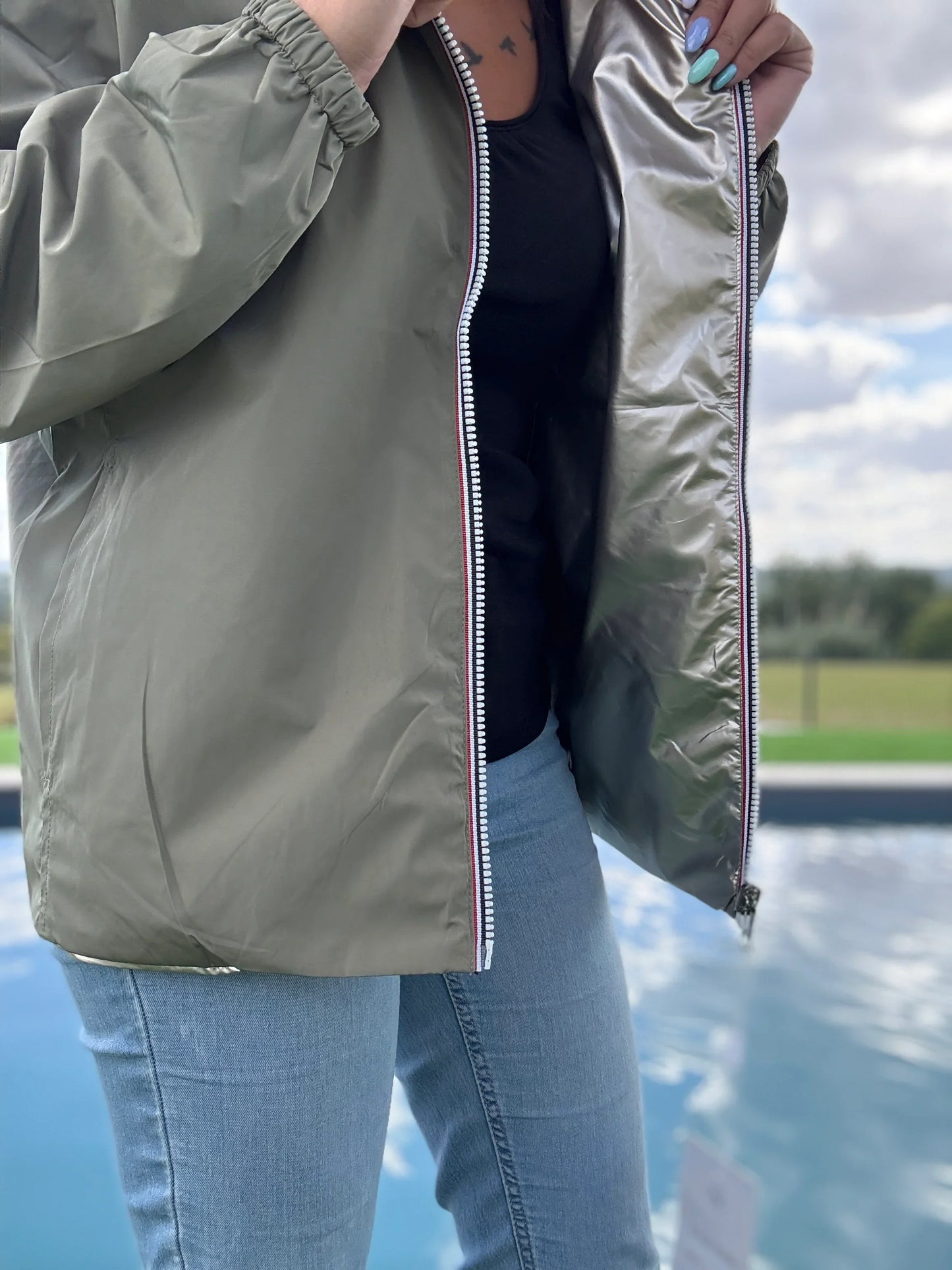 Manteau court léger imperméable réversible kaki et doré ouvert, doublure dorée visible, porté avec un jean