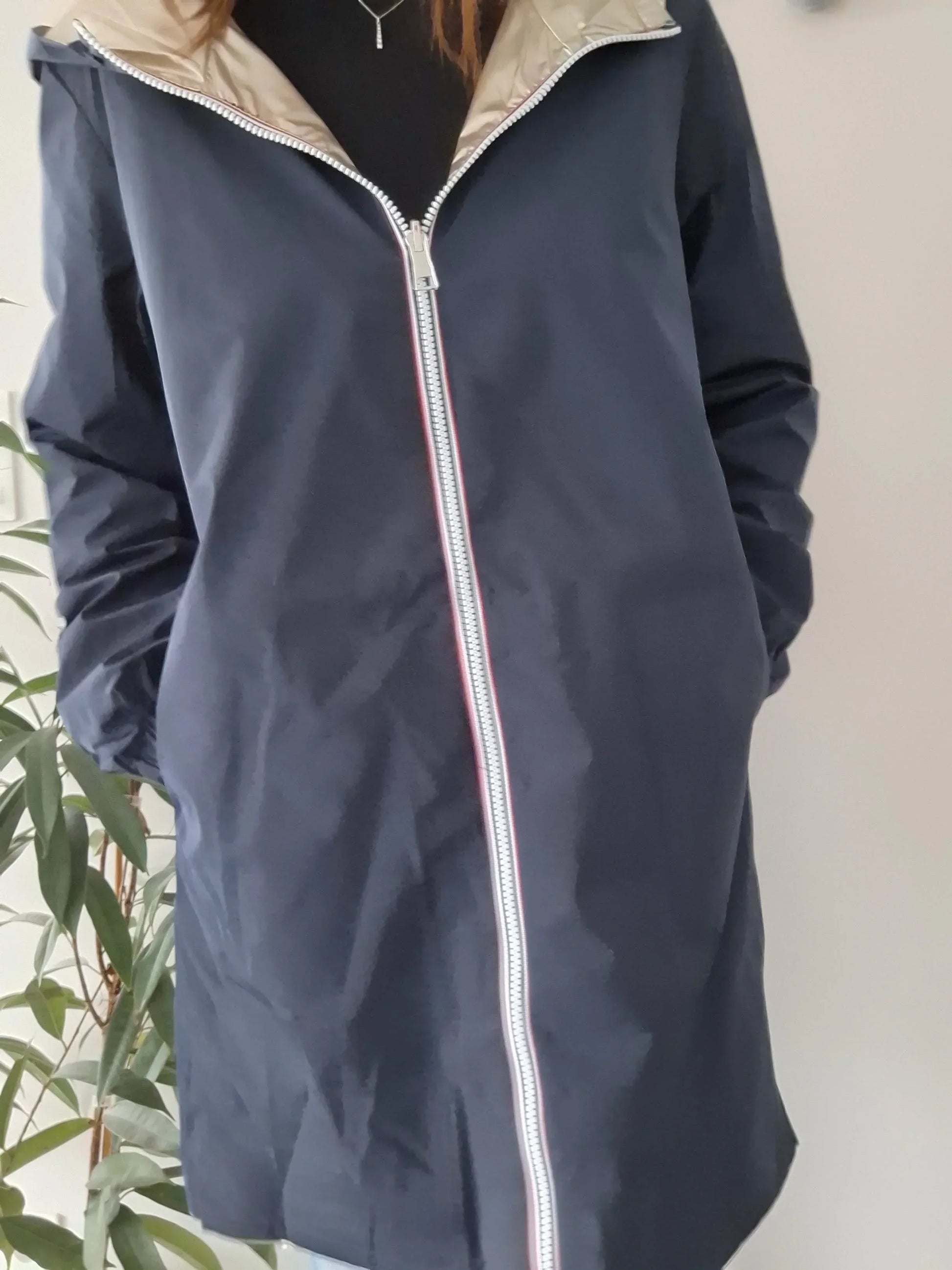 Woman wearing navy Laura Jo raincoat from Le Petit Placard, stylish zipped waterproof jacket