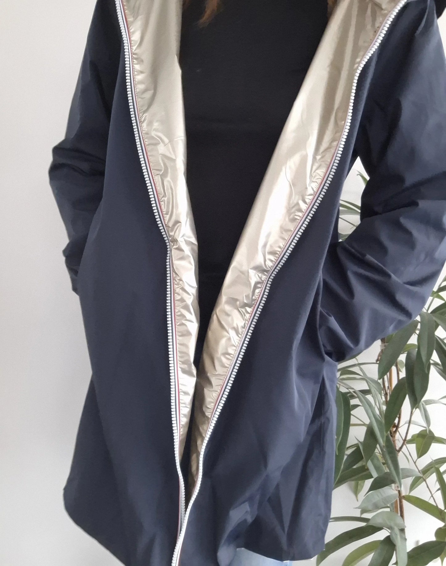 Woman modeling navy Laura Jo raincoat with shiny silver lining from Le Petit Placard