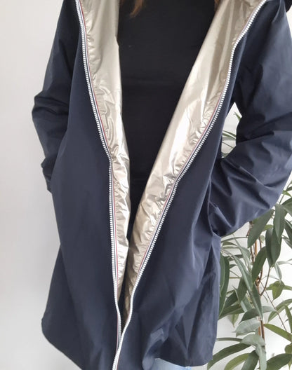 Woman modeling navy Laura Jo raincoat with shiny silver lining from Le Petit Placard