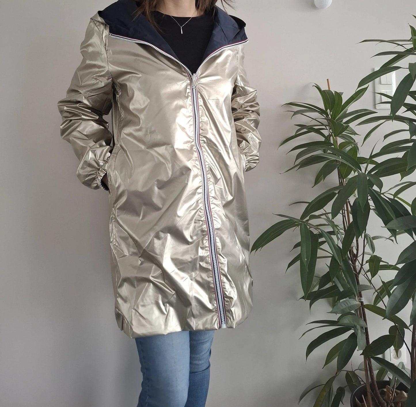 Woman wearing Laura Jo metallic raincoat, jeans, in modern room, Le Petit Placard fashion
