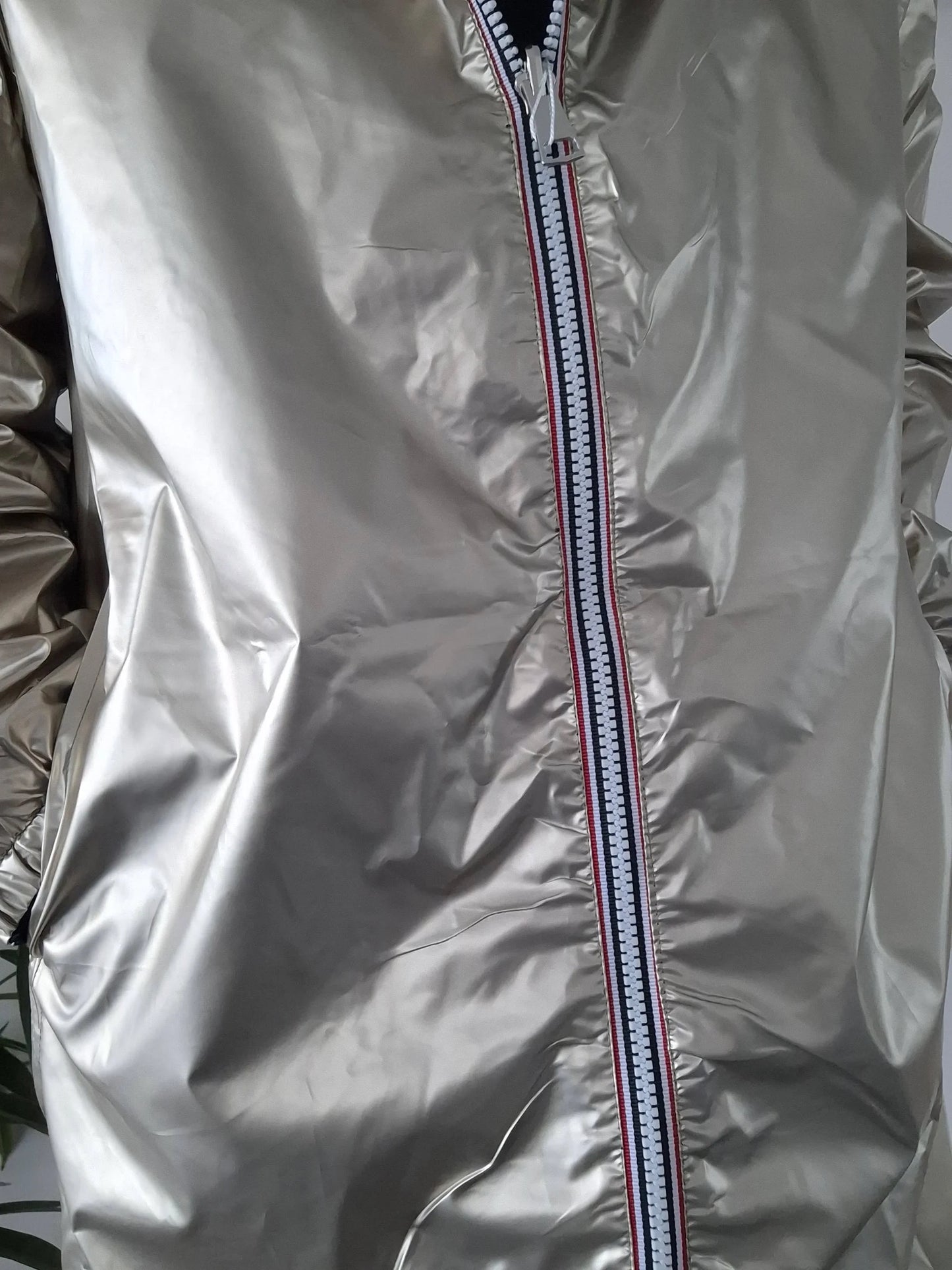 Close-up of silver Laura Jo raincoat with striped zipper, Le Petit Placard outerwear