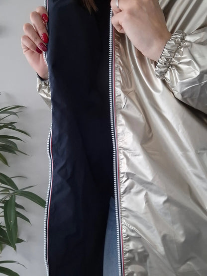 Woman showing inside of shiny Laura Jo raincoat, Le Petit Placard collection