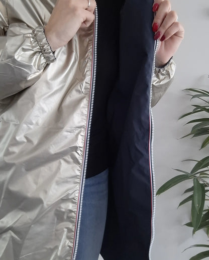 Woman showing interior of Laura Jo metallic raincoat from Le Petit Placard