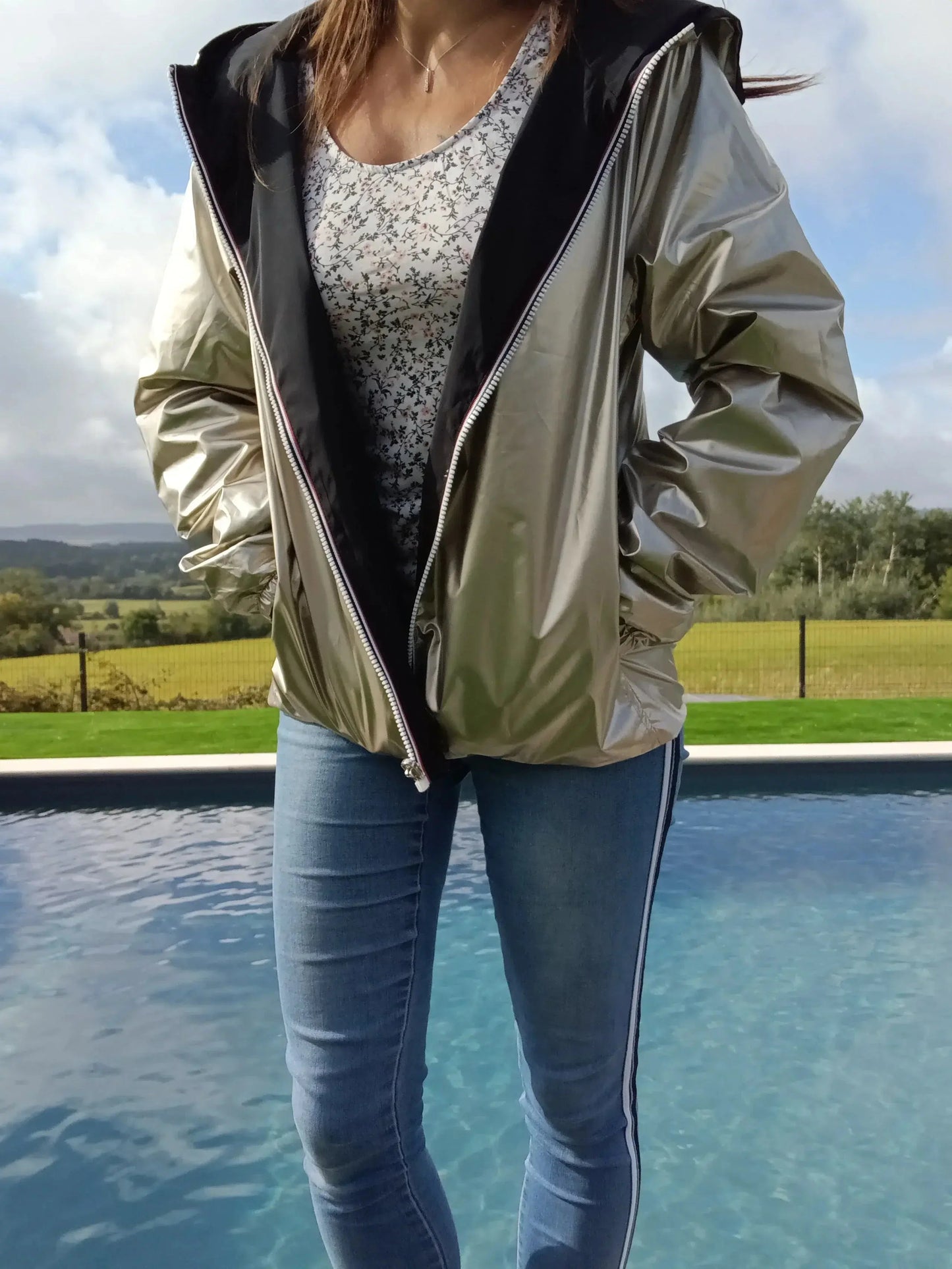 Manteau court réversible imperméable noir et doré de la marque Melya Melody, montré porté avec détails visibles.