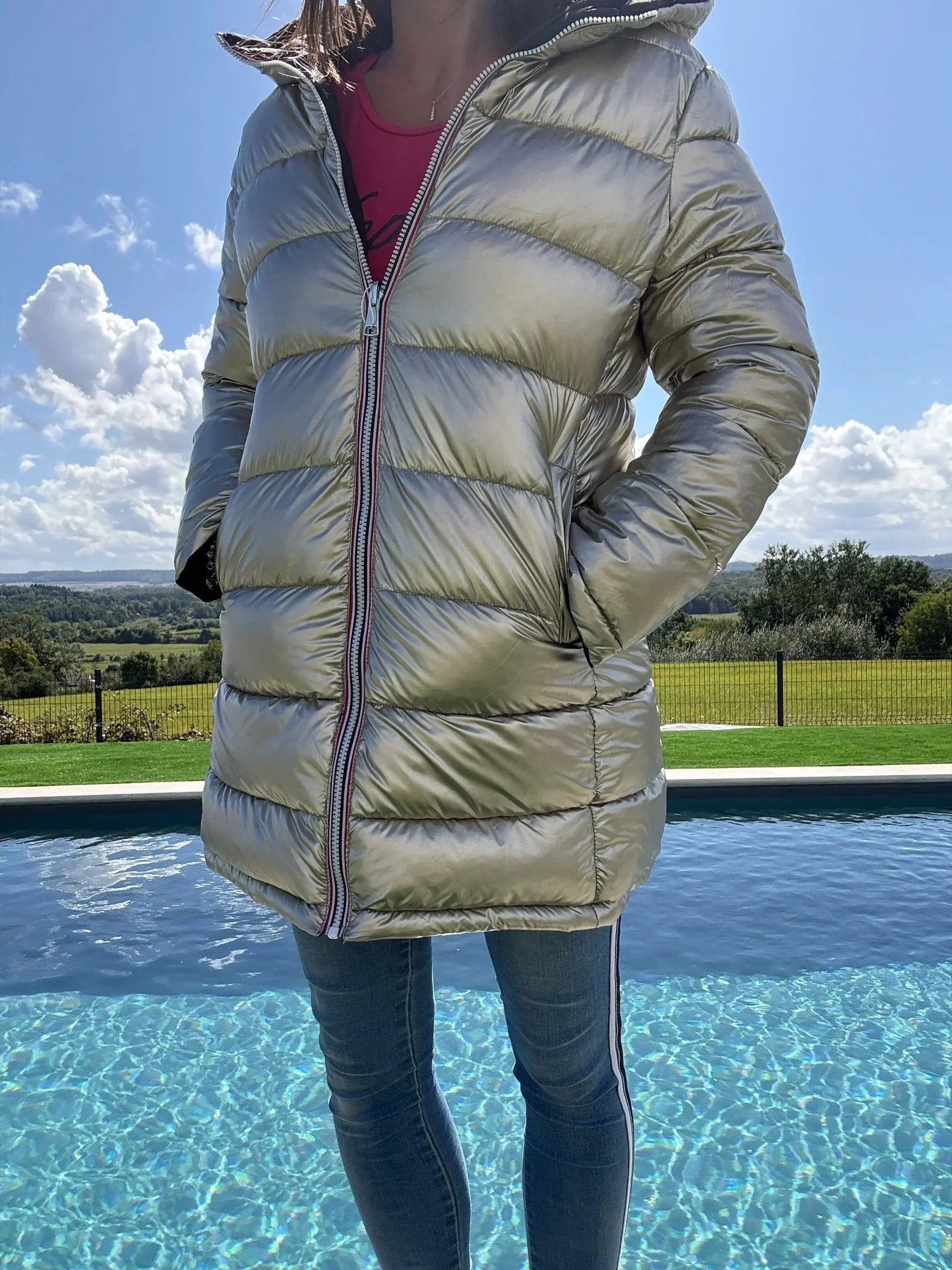 Manteau long réversible Melya Melody, imperméable et matelassé noir/doré, porté par un mannequin, vue de face.