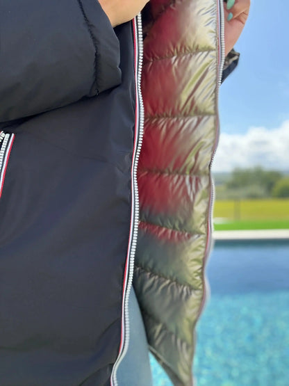 Manteau long réversible Melya Melody, imperméable et matelassé noir/doré, avec doublure visible en image.