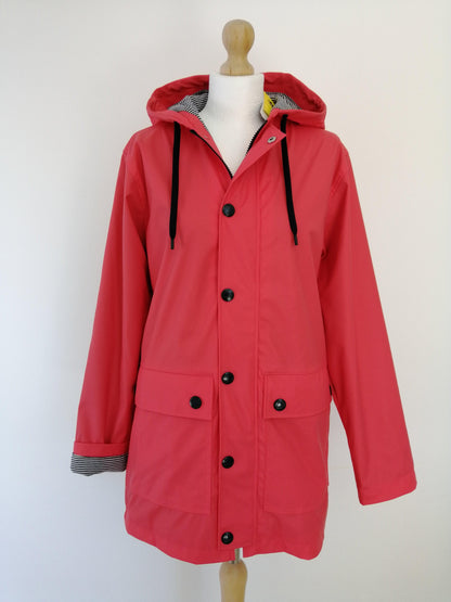 Pink Laura Jo raincoat with hood and black buttons on mannequin, Le Petit Placard