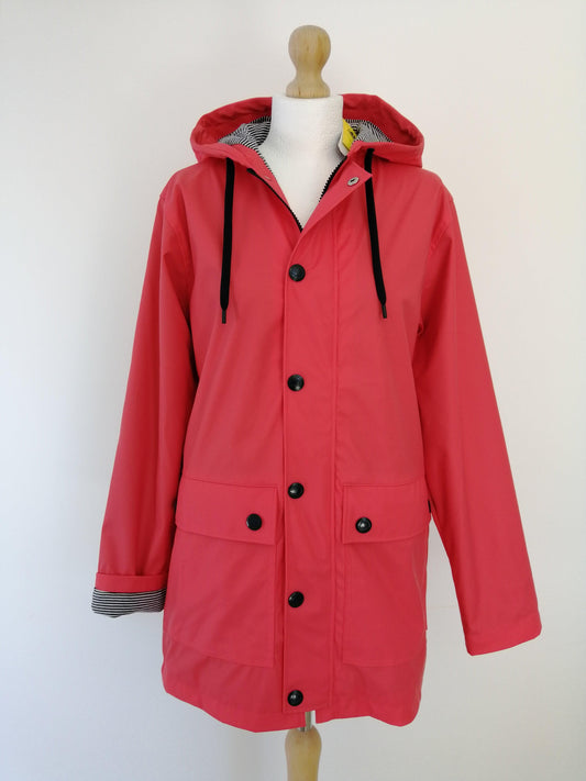 Pink Laura Jo raincoat with hood and black buttons on mannequin, Le Petit Placard