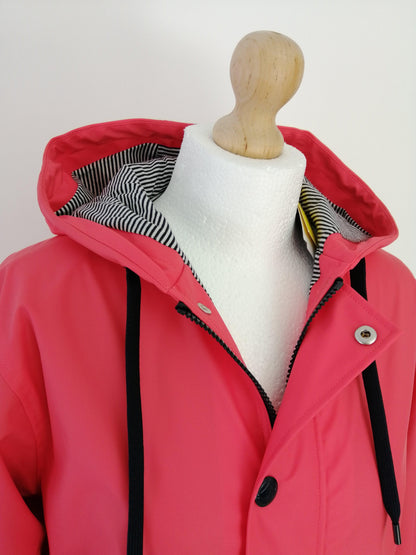Red Laura Jo raincoat with striped hood lining displayed on mannequin, Le Petit Placard