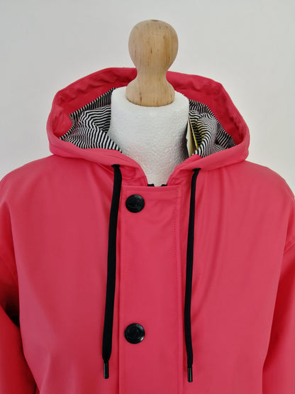 Red Laura Jo raincoat with hood and black buttons, displayed on mannequin, Le Petit Placard