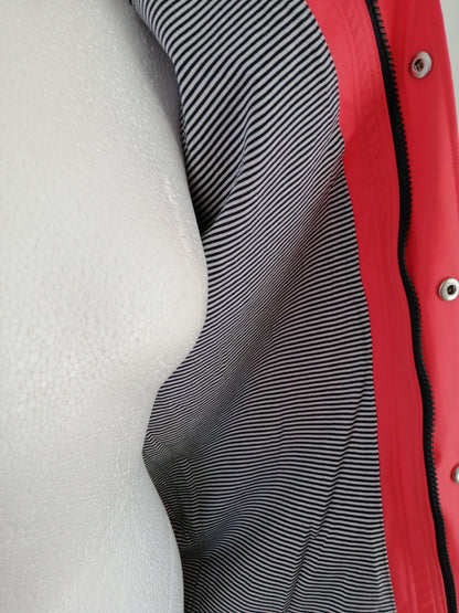 Close-up of a mannequin wearing a pink raincoat with striped lining from Le Petit Placard.